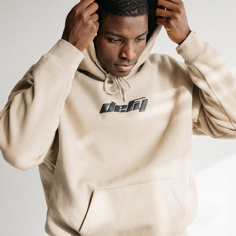 Tan::Tan hoodie with defy logo on front